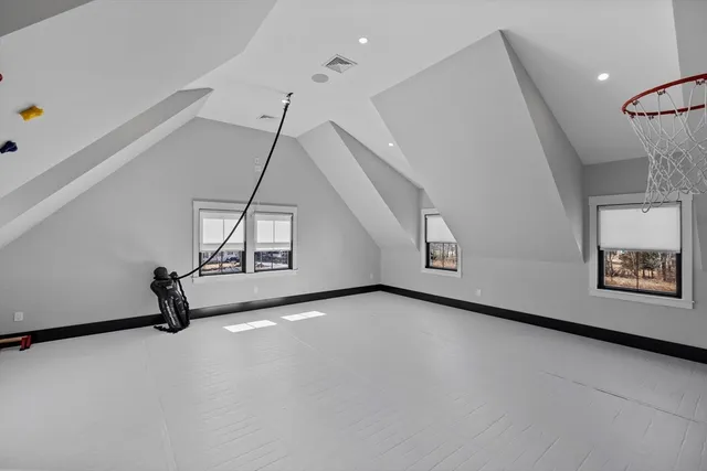 a room with gym equipment and windows