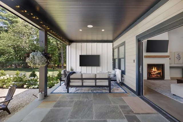 a view of a livingroom with furniture and floor to ceiling window