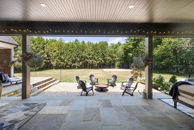 a building outdoor space with patio furniture and potted plants