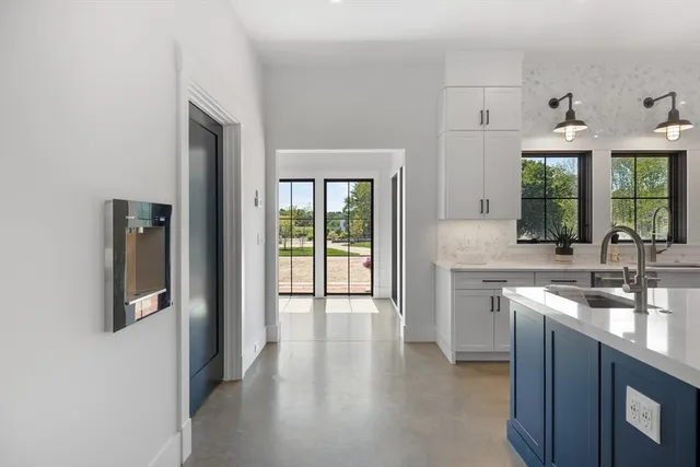 a open kitchen with granite countertop a sink and a stove top oven