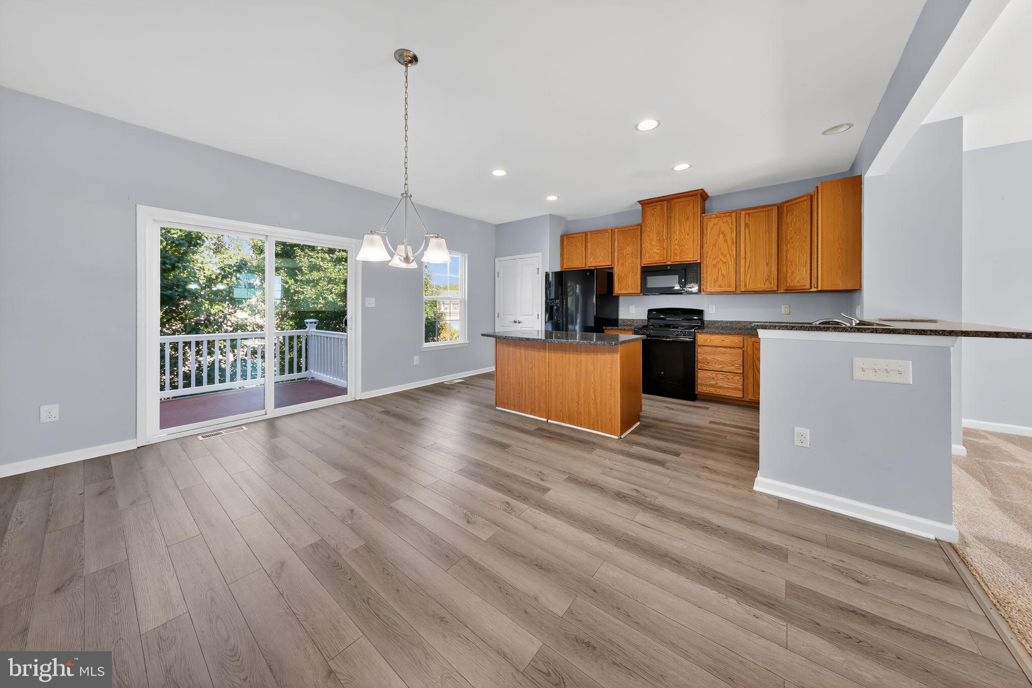 633 Barrie Road Middletown, DE 19709 - Photo 9 of 15 a kitchen with stainless steel appliances granite countertop wooden floors sink and window