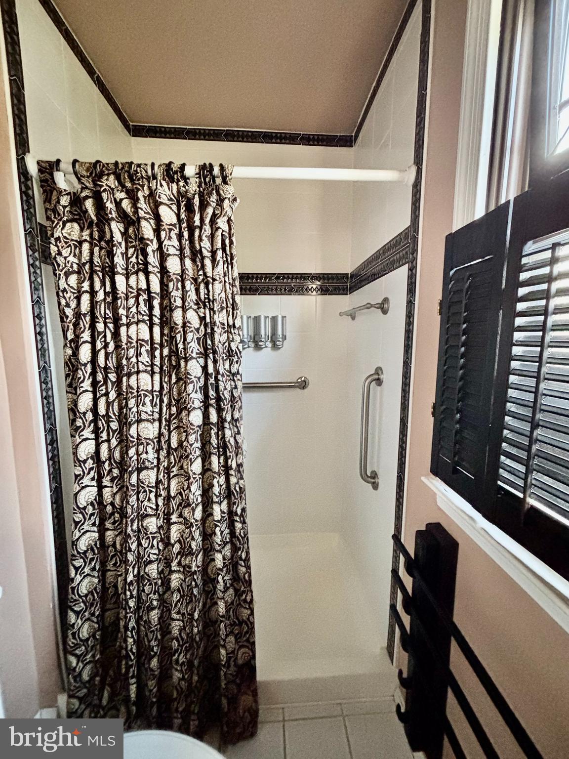 511 Boundary Road Pitman, NJ 08071 - Photo 20 of 30 a bathroom with a shower curtain and a sink