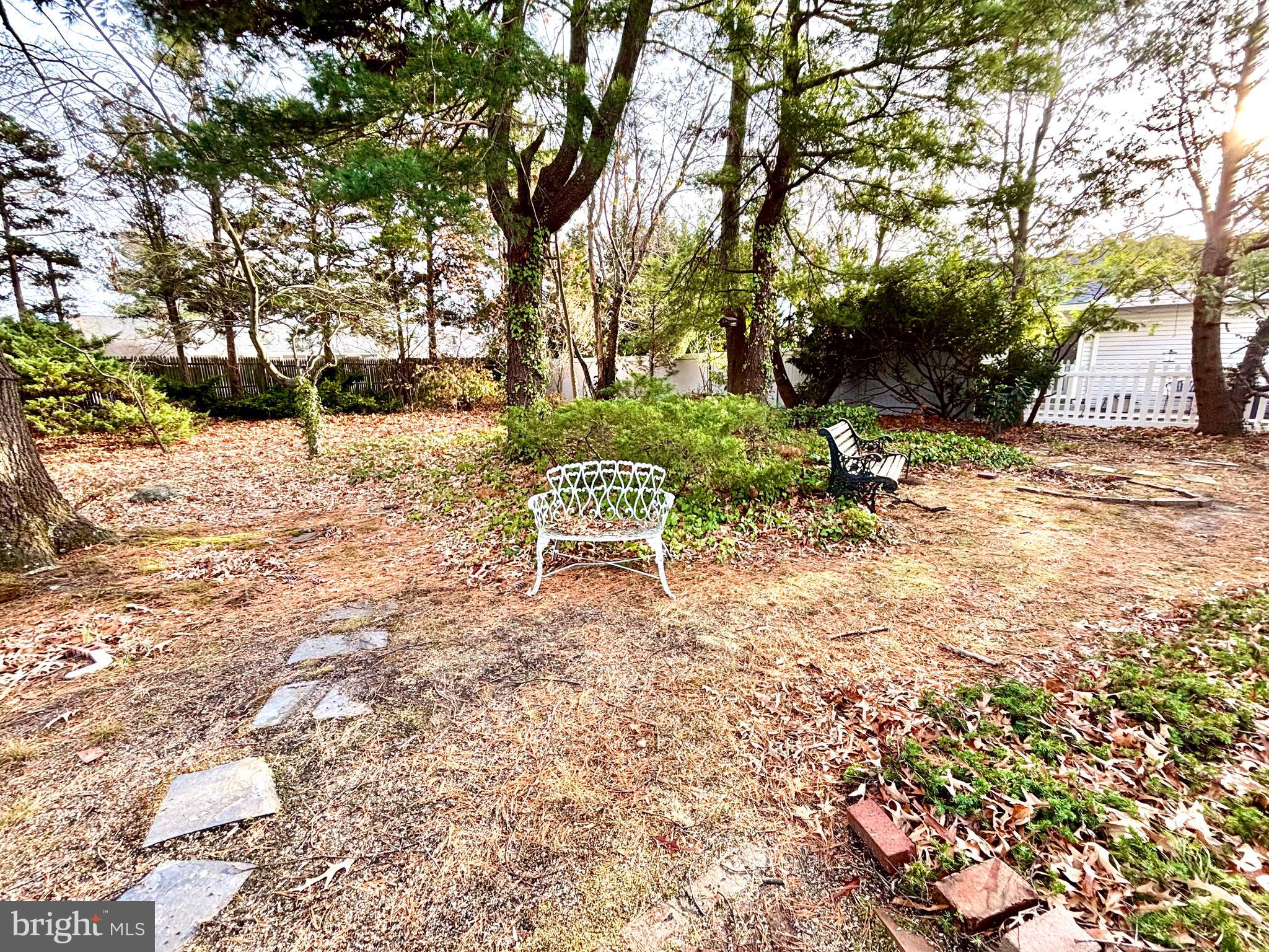 511 Boundary Road Pitman, NJ 08071 - Photo 26 of 30 a wooden bench sitting in the middle of a yard