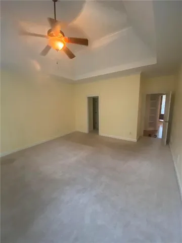 a view of a livingroom with an empty space and a window