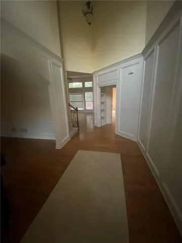 a kitchen with granite countertop a refrigerator and cabinets