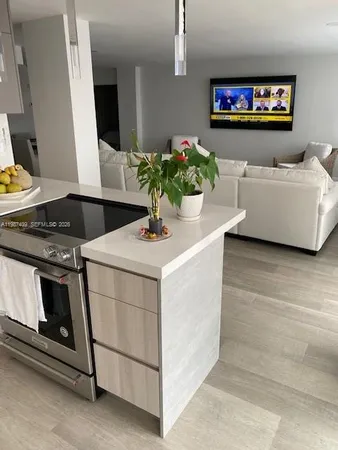 a kitchen with stainless steel appliances a stove microwave and white cabinets