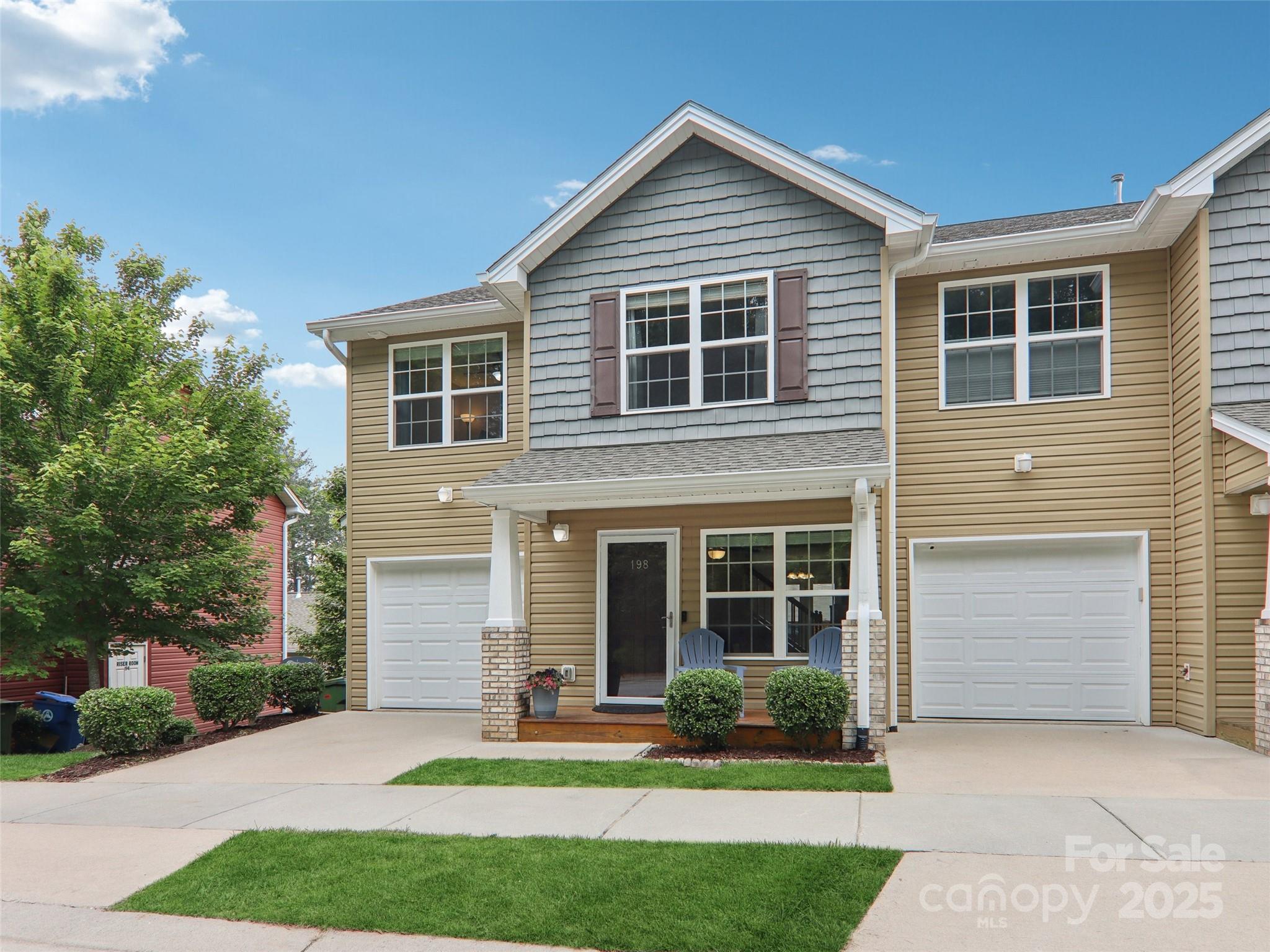 a front view of a house with a yard and porch