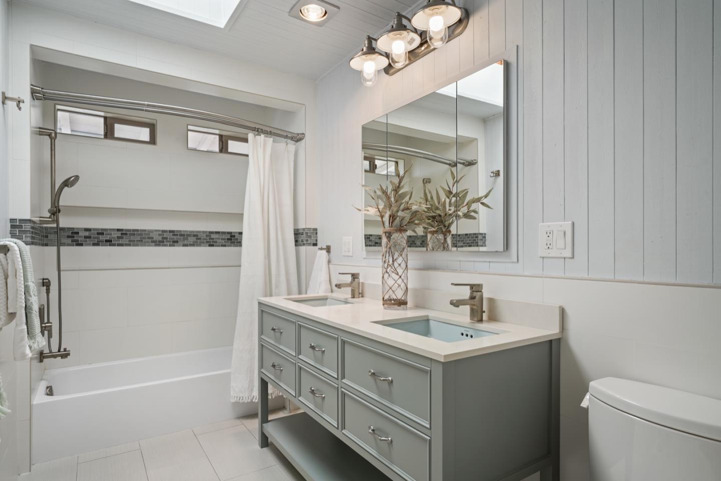 7440 Viewpoint Road Aptos, CA 95003 - Photo 25 of 39 a bathroom with a sink vanity granite toilet and a mirror