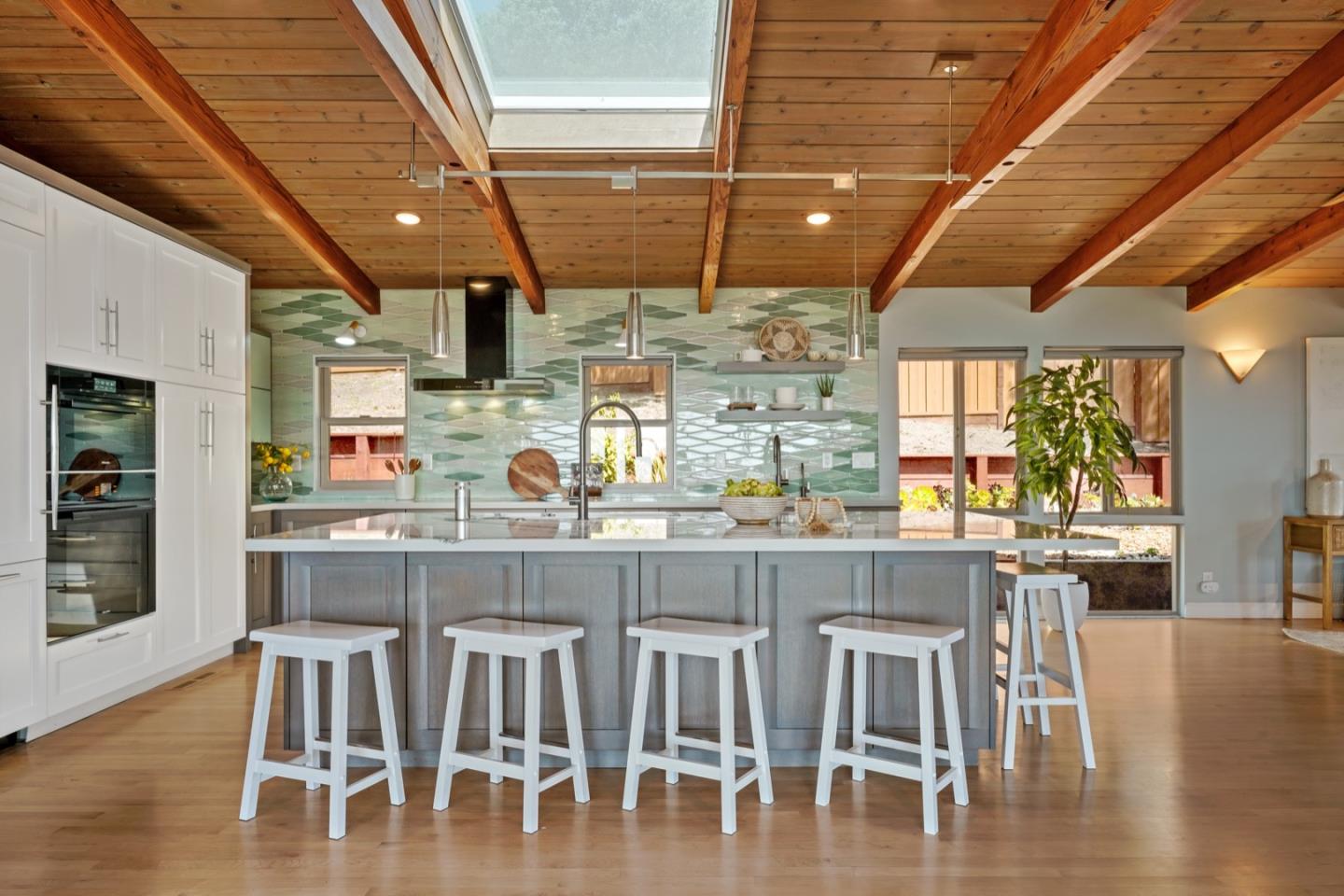 7440 Viewpoint Road Aptos, CA 95003 - Photo 7 of 39 a kitchen with wooden floors and chairs