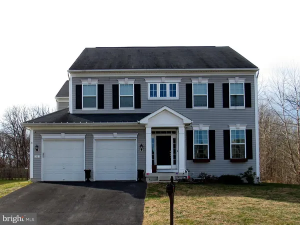 a front view of a house with yard