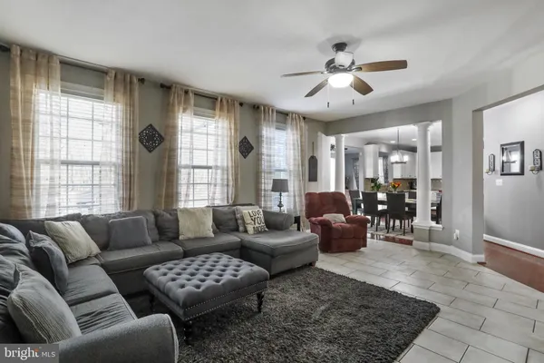 a living room with furniture and a chandelier