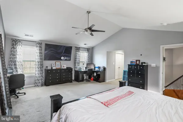 a bedroom with a bed and ceiling fan