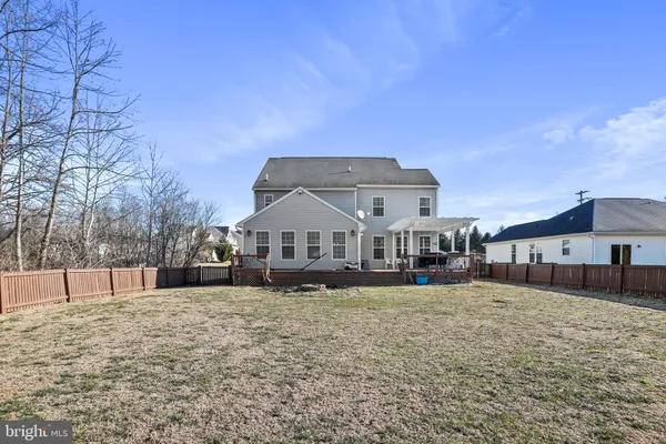 a view of a house with a yard covered in snow