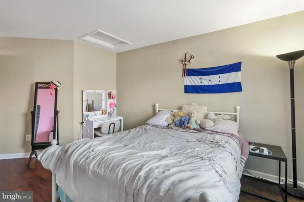 a bedroom with a bed and a lamp