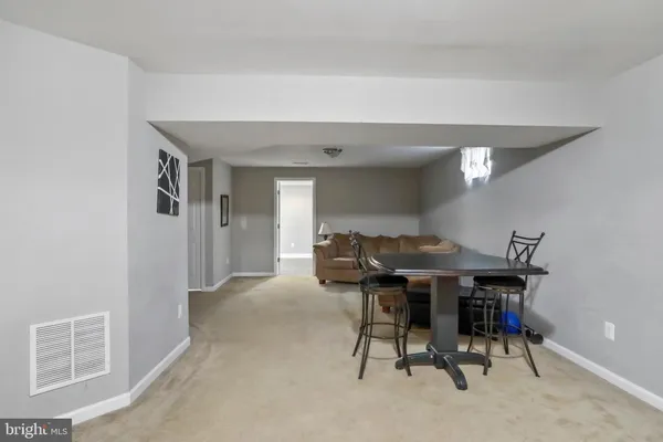 a view of a livingroom with furniture and a window