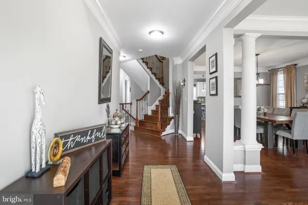a view of entryway and hall with wooden floor