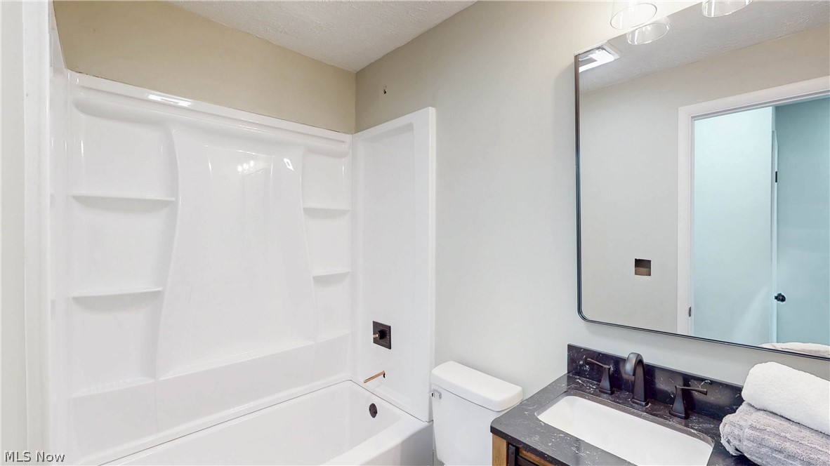3312 Bancroft Road Akron, OH 44333 - Photo 27 of 50 Full bathroom with vanity, shower / washtub combination, and a textured ceiling