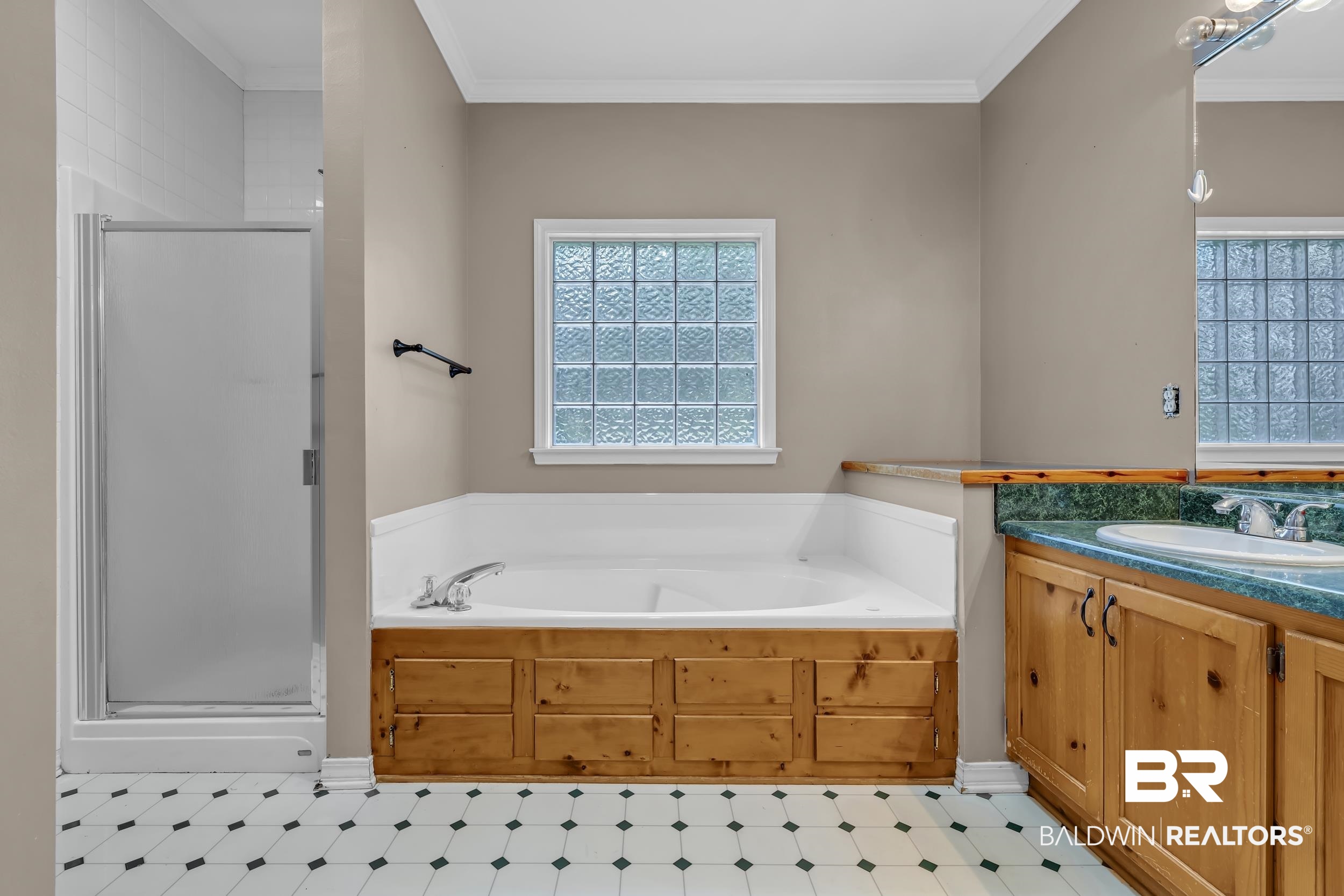 14960 Howells Ferry Road Wilmer, AL 36587 - Photo 14 of 22 Soaking tub with wooden surround and glass block window