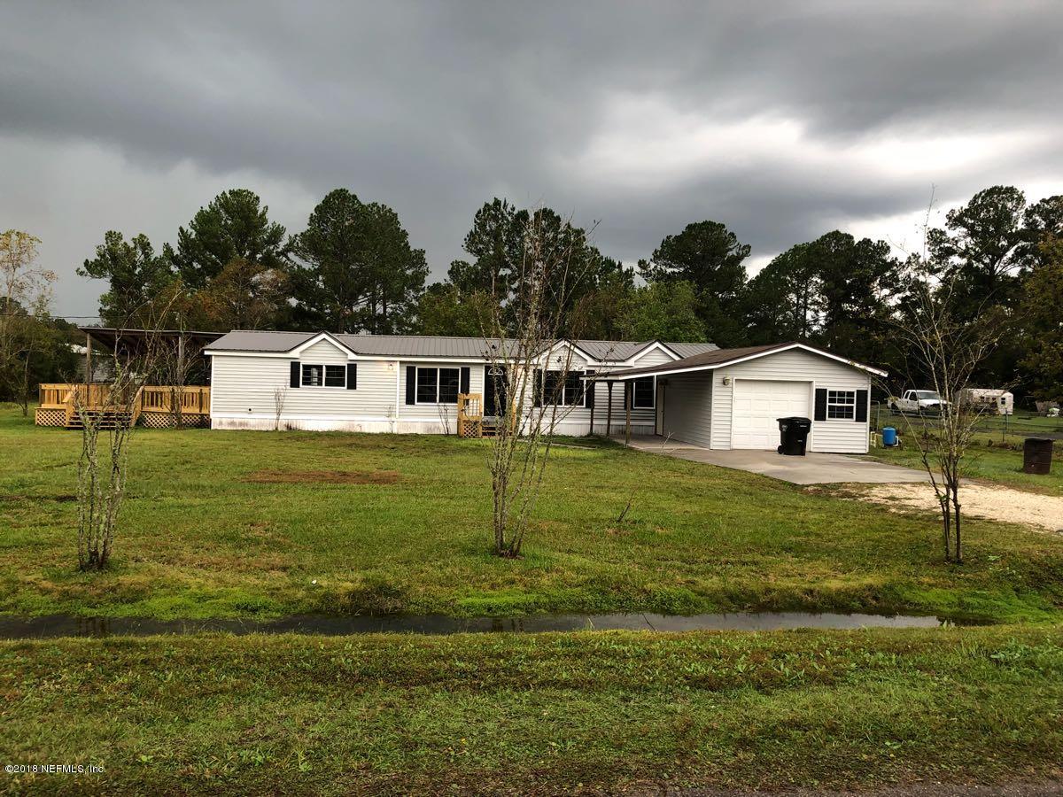 54254 Heller Road Callahan, FL 32011 - Photo 1 of 25 a white house with a yard and sitting space