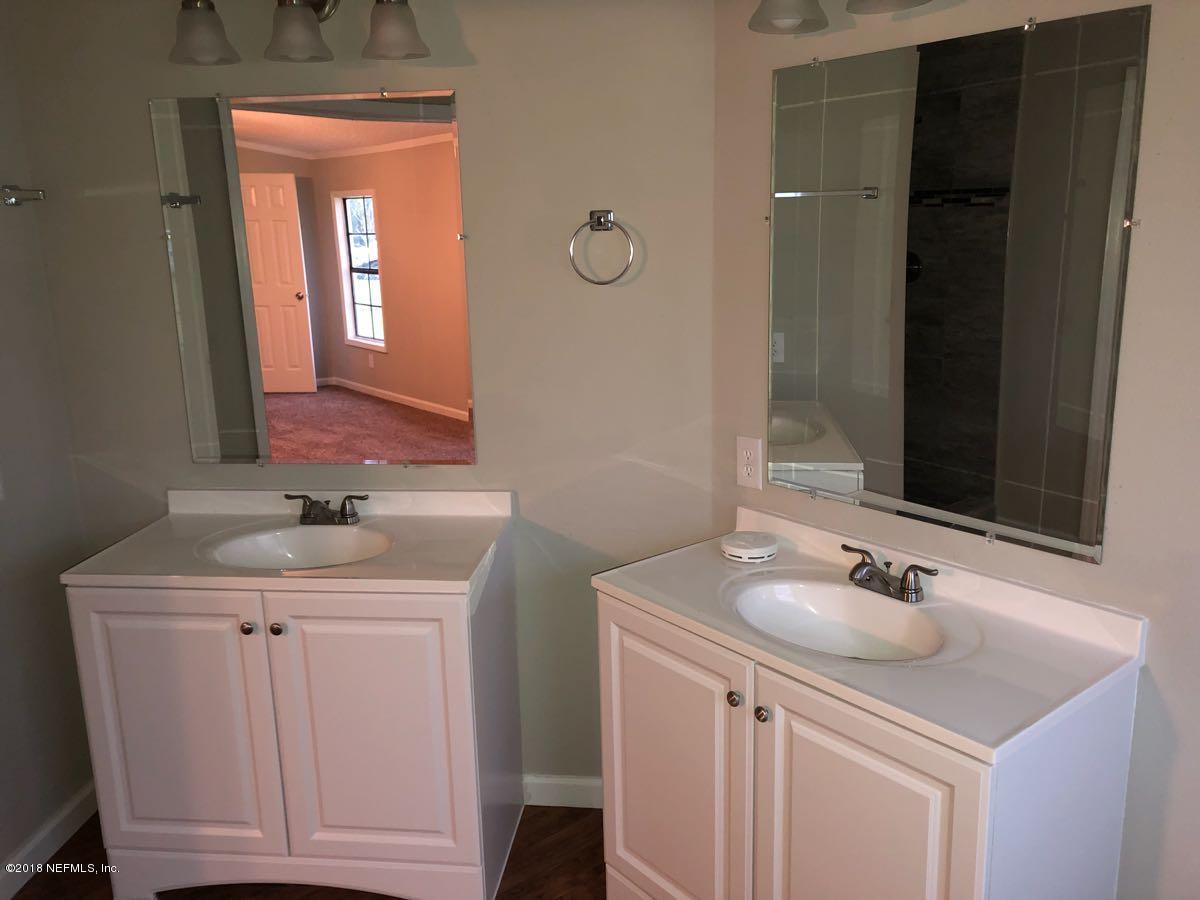 54254 Heller Road Callahan, FL 32011 - Photo 12 of 25 a bathroom with a sink and a mirror