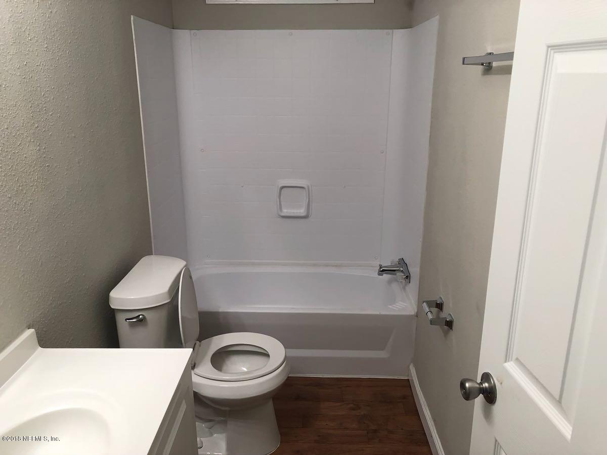 54254 Heller Road Callahan, FL 32011 - Photo 18 of 25 a bathroom with a sink a toilet and shower
