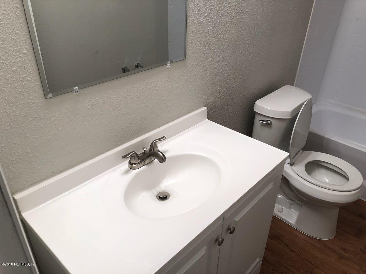 54254 Heller Road Callahan, FL 32011 - Photo 19 of 25 a bathroom with a sink a toilet and a mirror