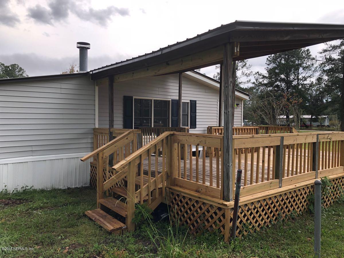 54254 Heller Road Callahan, FL 32011 - Photo 24 of 25 a view of a deck with wooden floor and fence