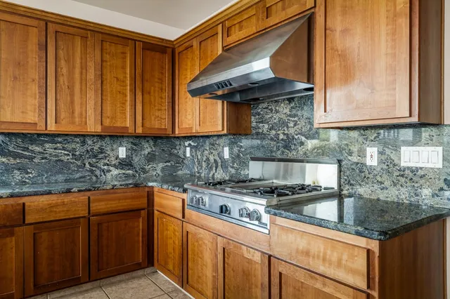 a kitchen with stainless steel appliances granite countertop a sink and cabinets