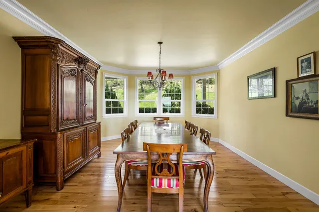 a living room with furniture stove and a table