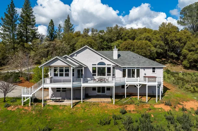 an aerial view of a house with a yard and potted plants