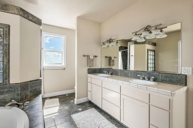 a view of a roof deck with table and chairs a barbeque with wooden floor and fence
