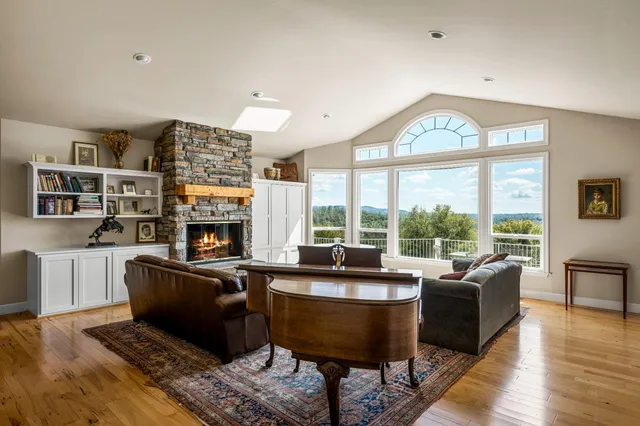 a living room with furniture a flat screen tv and a fireplace