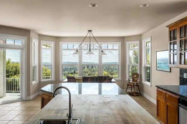 a large kitchen with stainless steel appliances granite countertop a large stove a sink a microwave and island