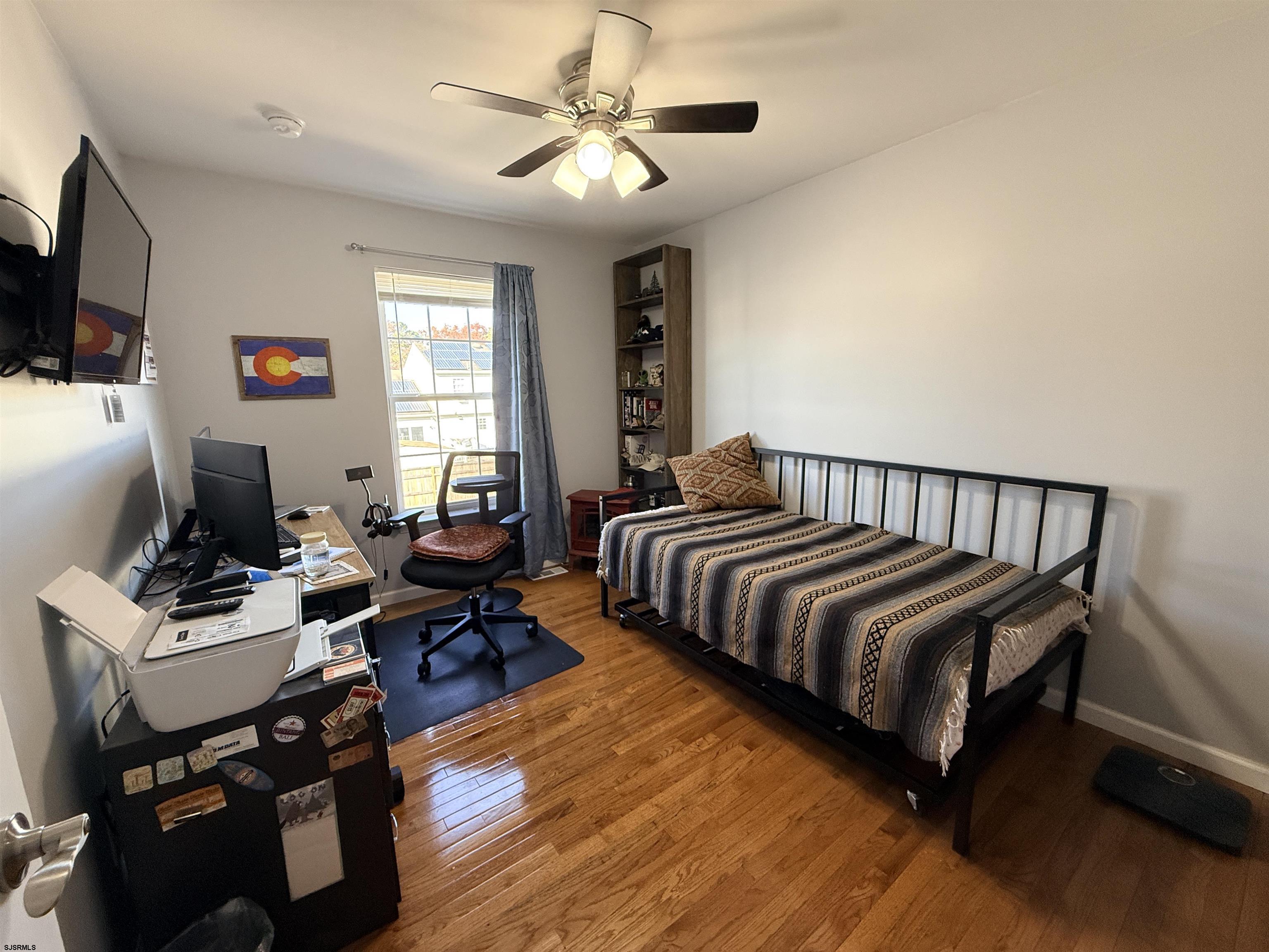 477 Damson Avenue Galloway Township, NJ 08205 - Photo 11 of 24 a bedroom with a bed and wooden floor