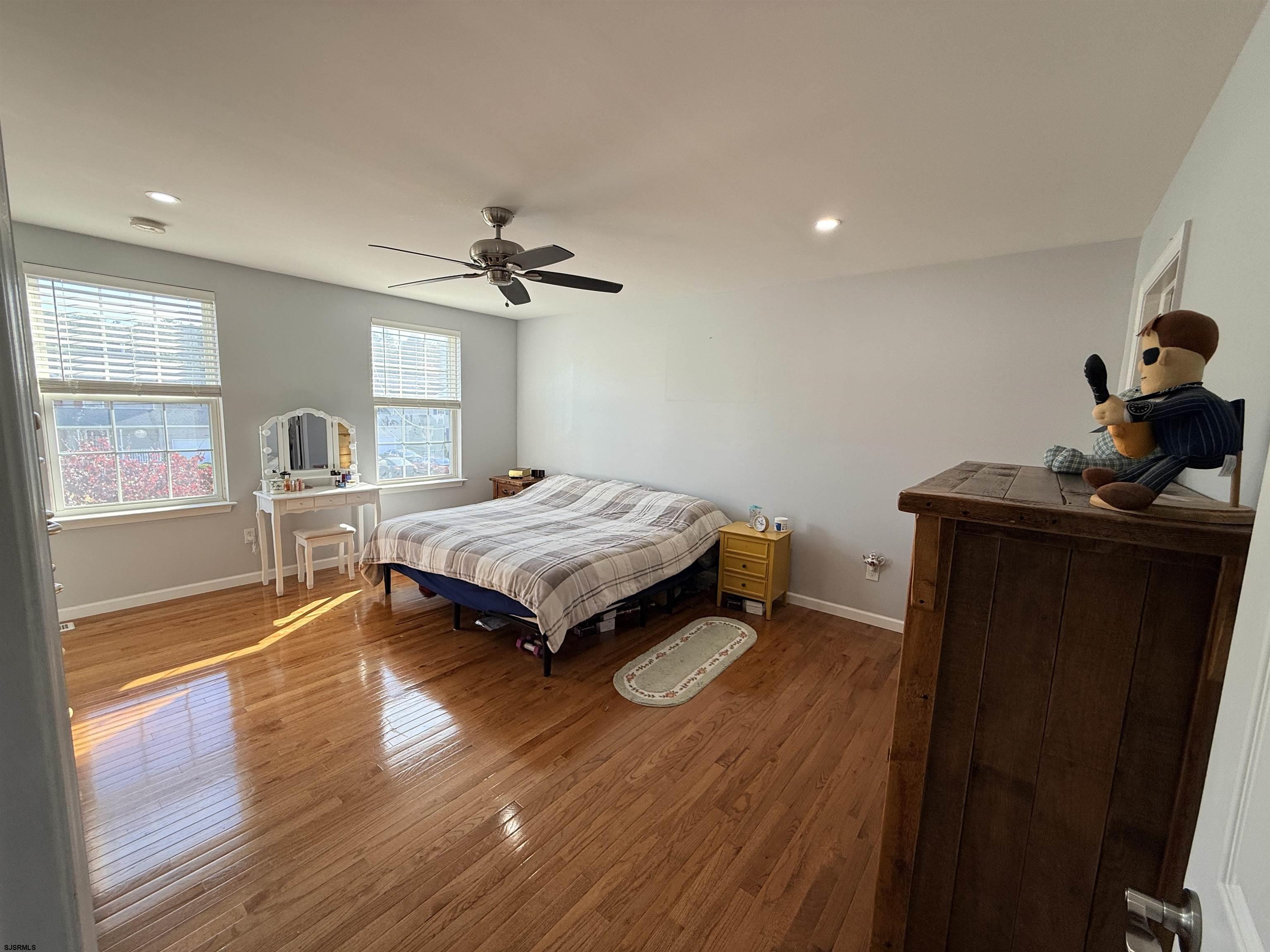 477 Damson Avenue Galloway Township, NJ 08205 - Photo 14 of 24 a bedroom with a bed and wooden floor