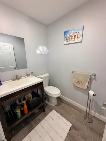 a bathroom with a sink a toilet and a mirror