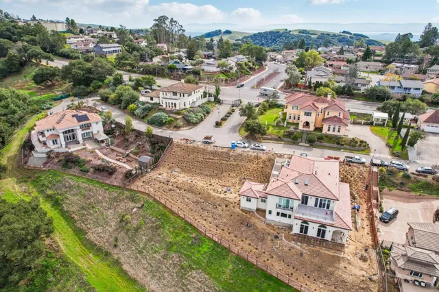an aerial view of residential houses with outdoor space