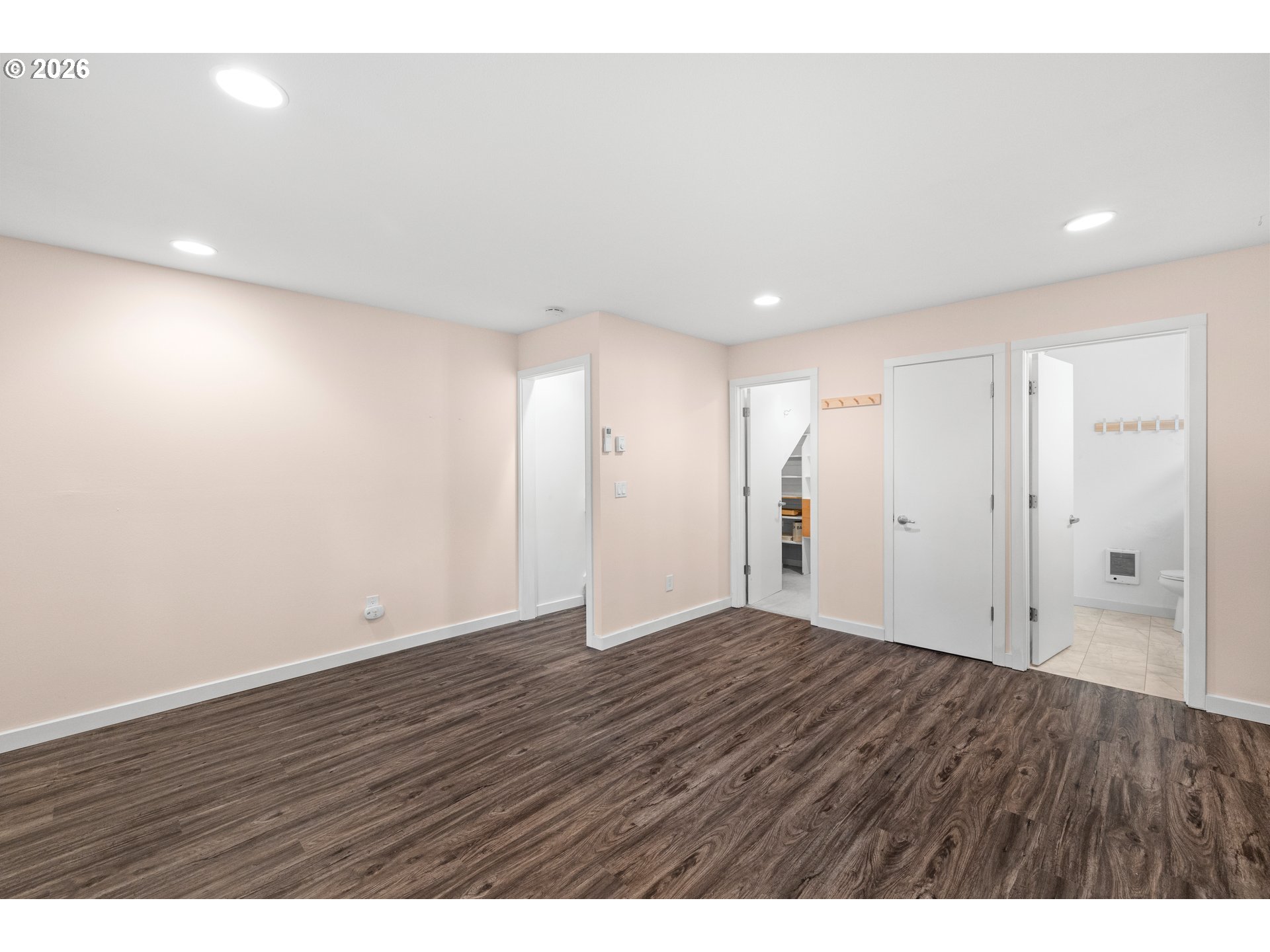 4594 Southwest Caldew Street, Unit A Portland, OR 97219 - Photo 19 of 29 a view of an empty room with wooden floor