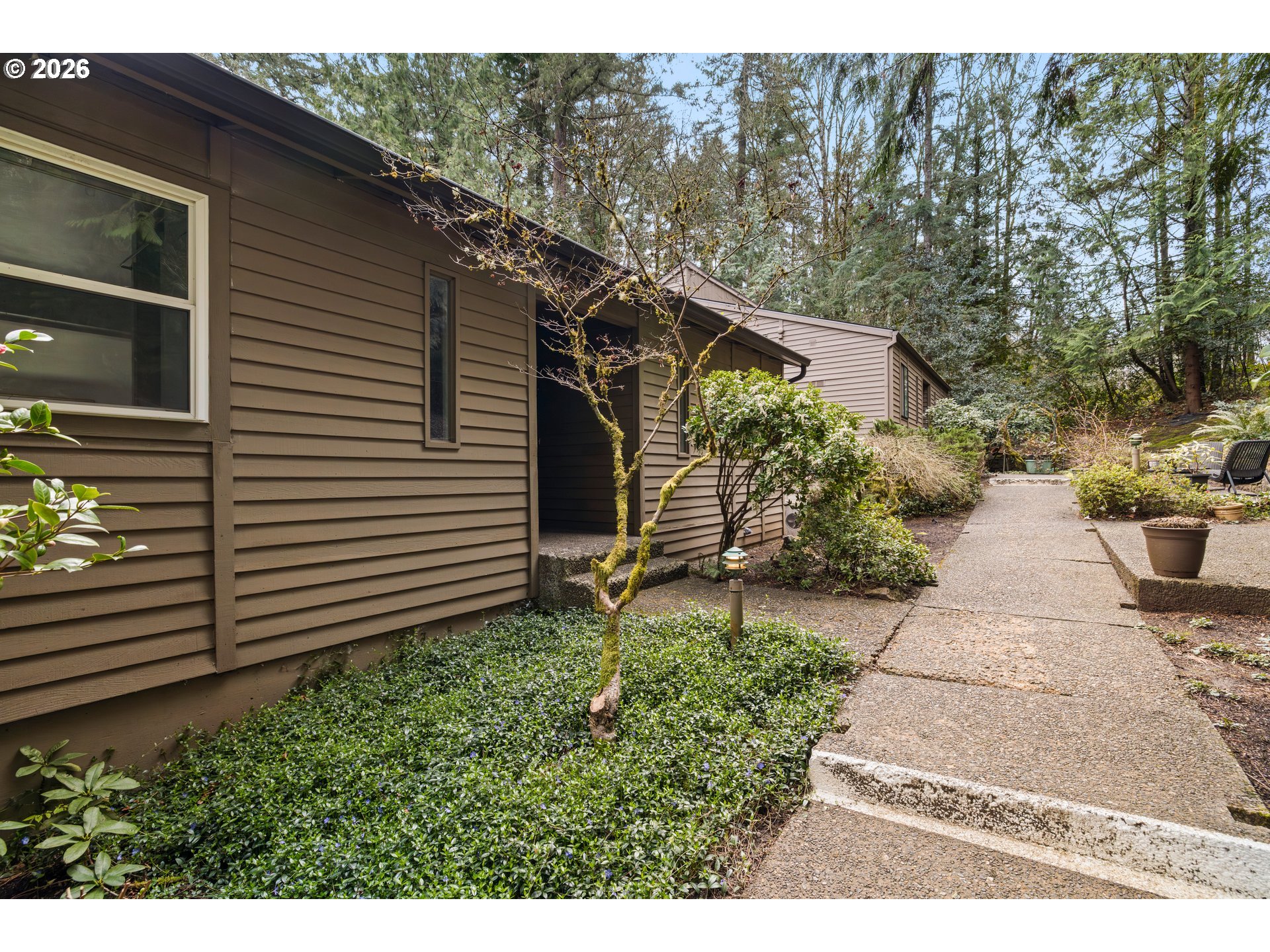 4594 Southwest Caldew Street, Unit A Portland, OR 97219 - Photo 2 of 29 a backyard of a house with lots of green space