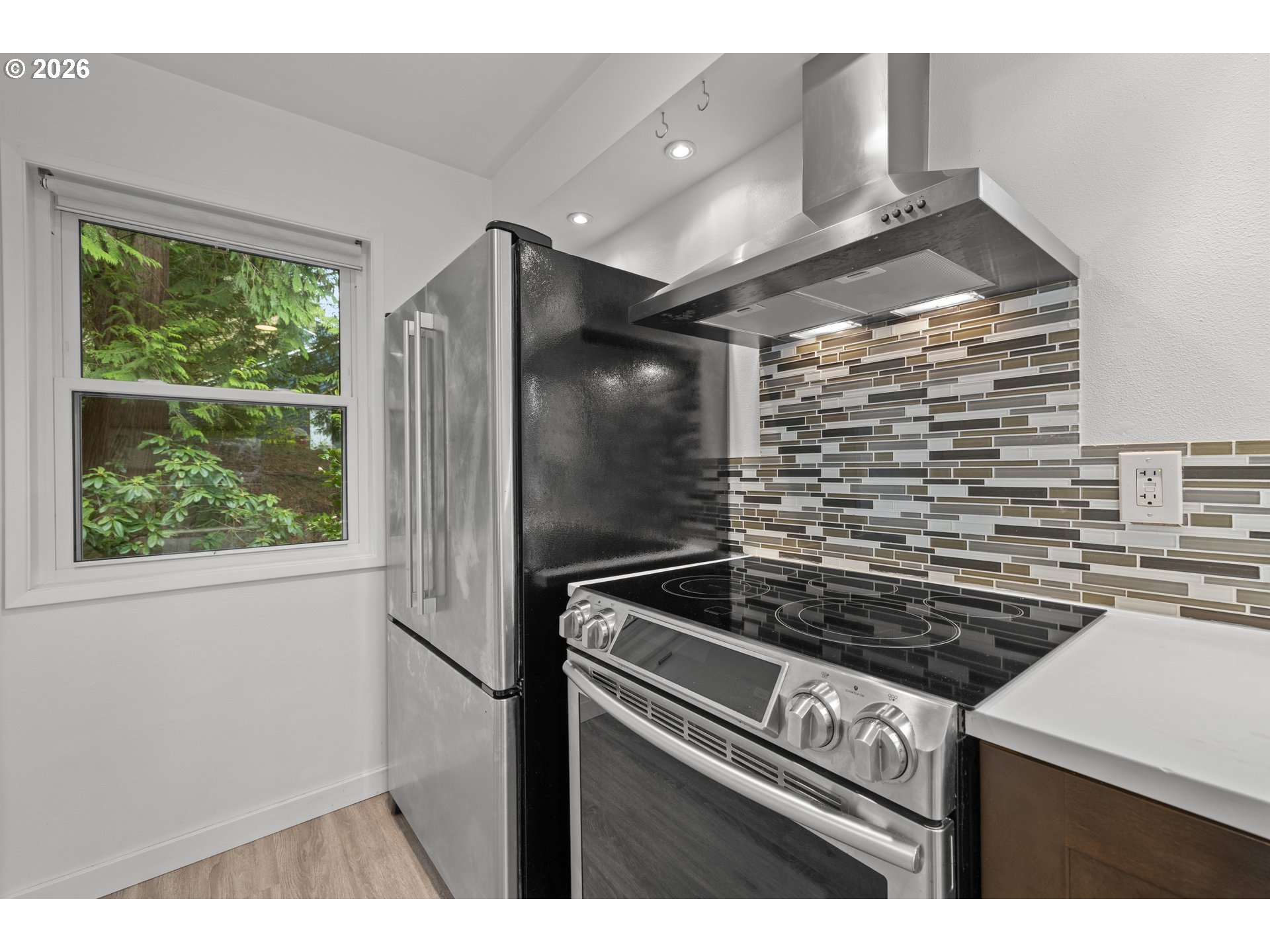 4594 Southwest Caldew Street, Unit A Portland, OR 97219 - Photo 7 of 29 a kitchen view with a stove and a refrigerator