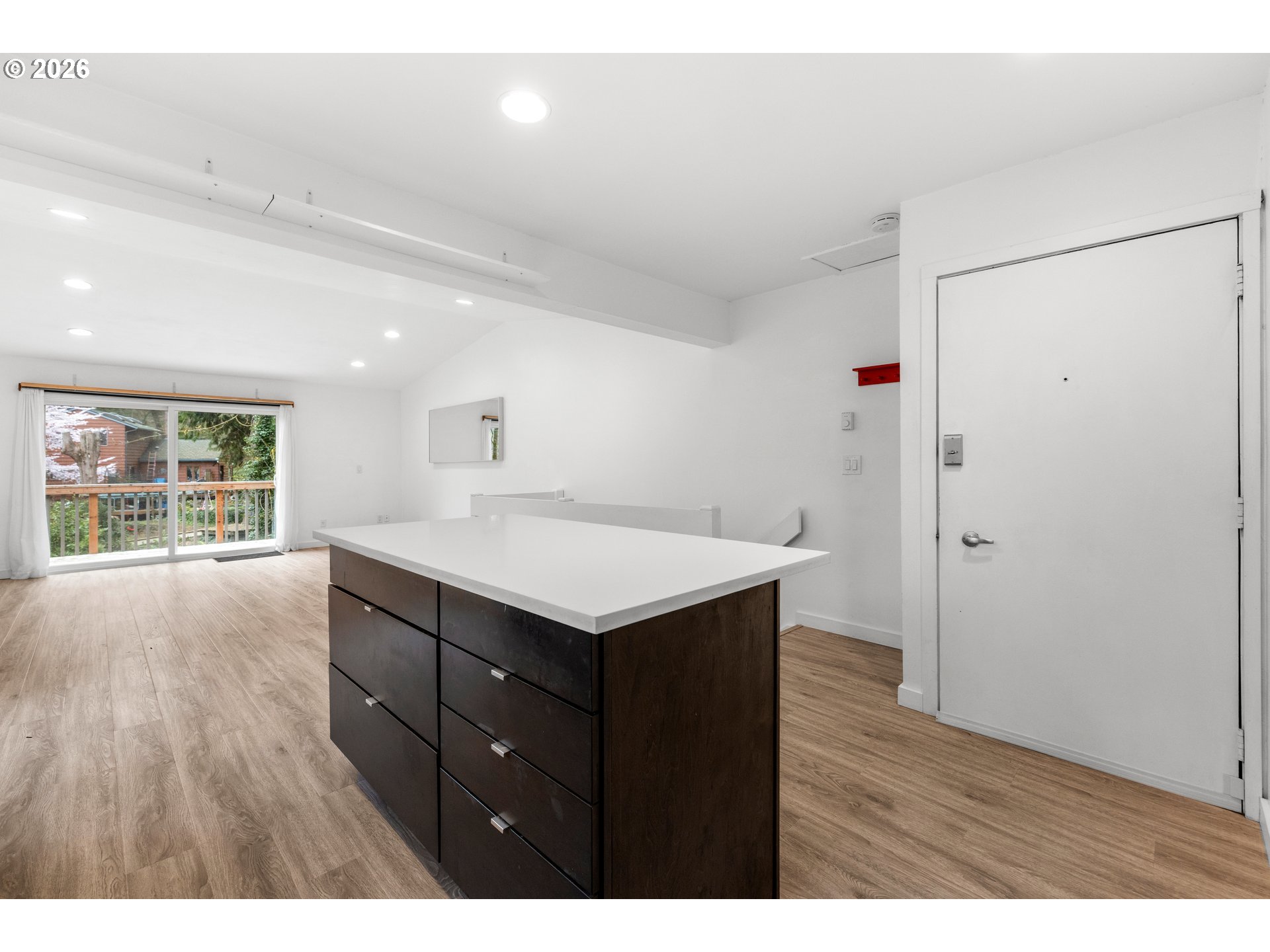 4594 Southwest Caldew Street, Unit A Portland, OR 97219 - Photo 8 of 29 a kitchen with a wooden floor and window