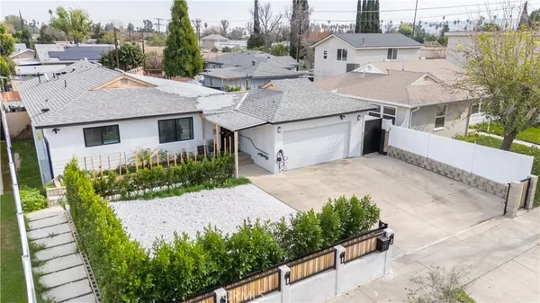 a aerial view of a house with a yard and potted plants