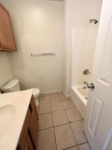 a bathroom with a sink a toilet and bathtub