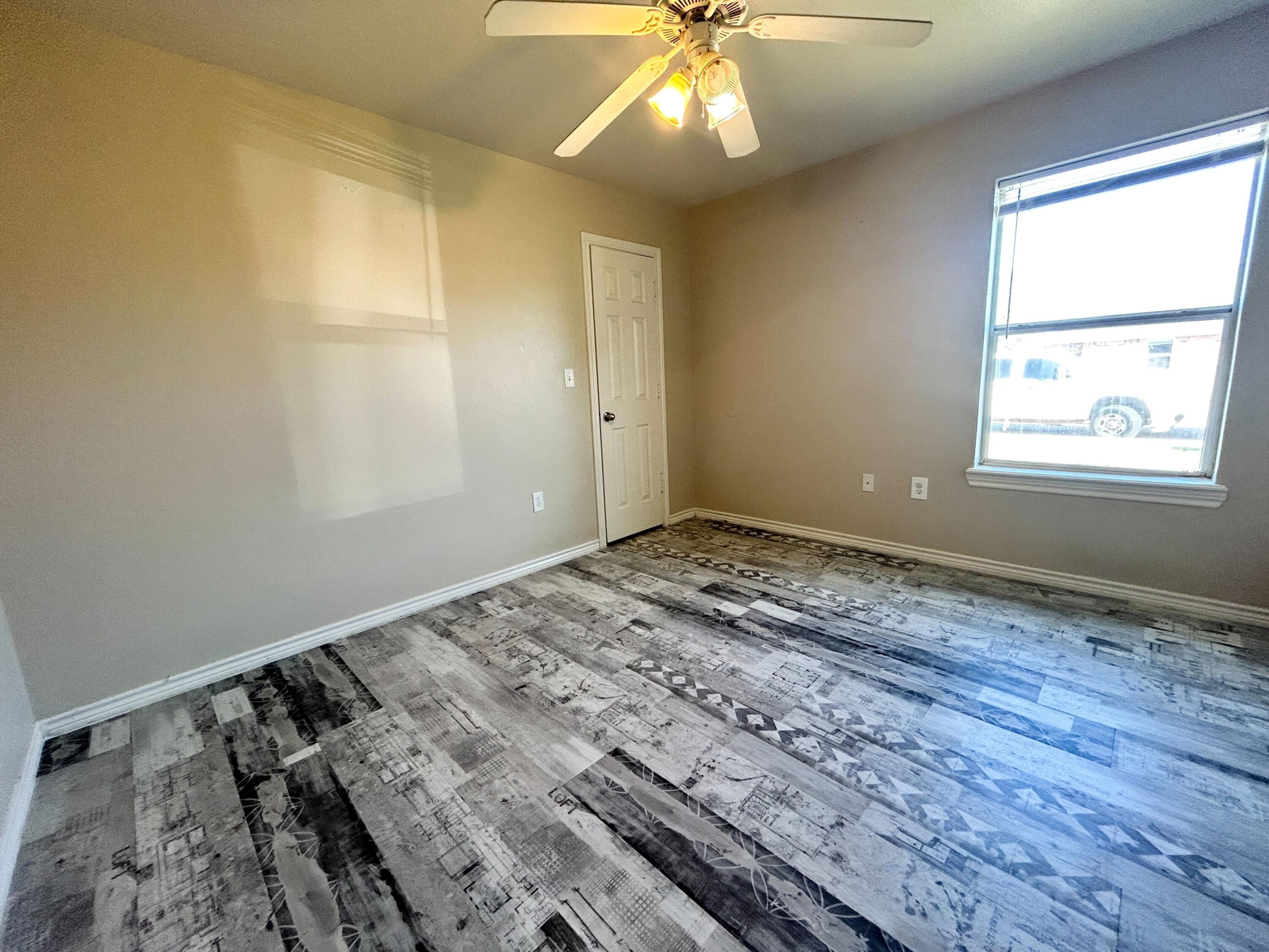 5413 Harvard Street, Unit B Lubbock, TX 79416 - Photo 7 of 10 a view of an empty room and window