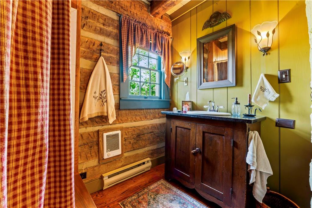 117 Havers Hill Road Jefferson, PA 15344 - Photo 26 of 44 a bathroom with a sink a mirror and next to a window