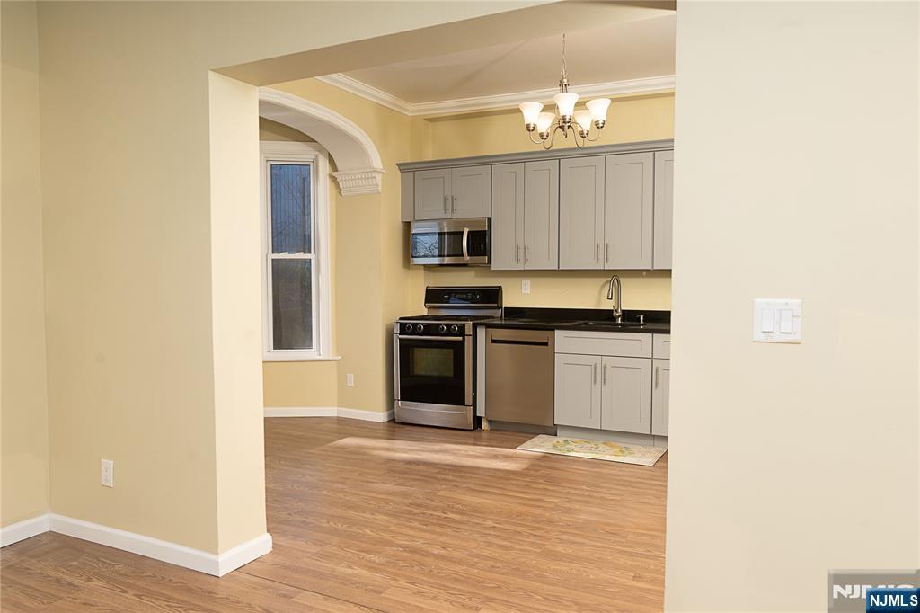 37 Riverside Avenue Little Ferry, NJ 07643 - Photo 10 of 34 a kitchen with granite countertop white cabinets and stainless steel appliances