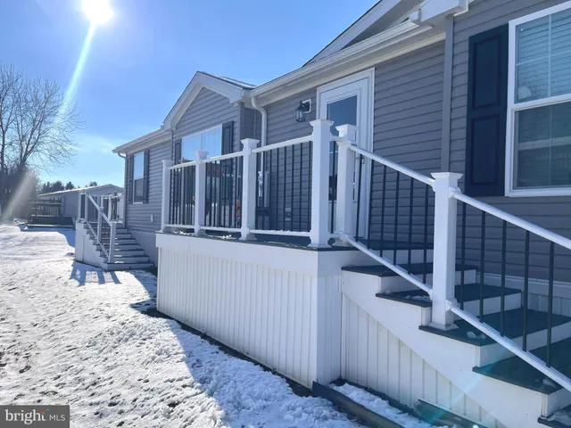 a view of a house with wooden fence