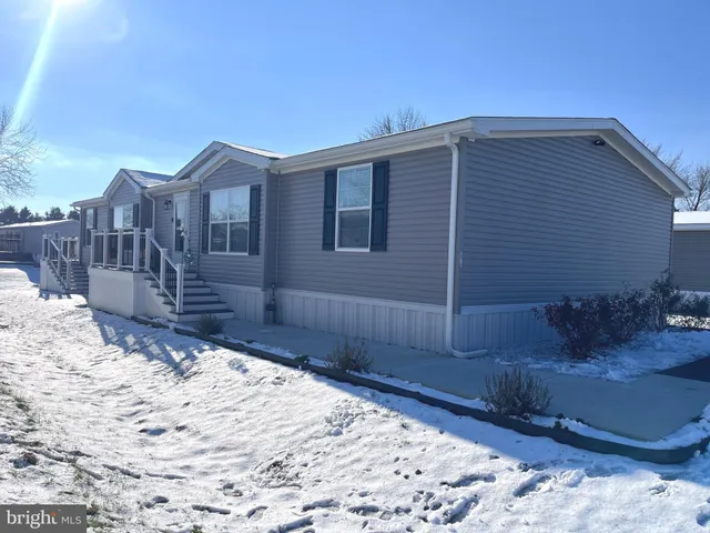 a kitchen with a dining table chairs and refrigerator