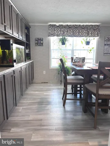 a living room with furniture a chandelier and a rug