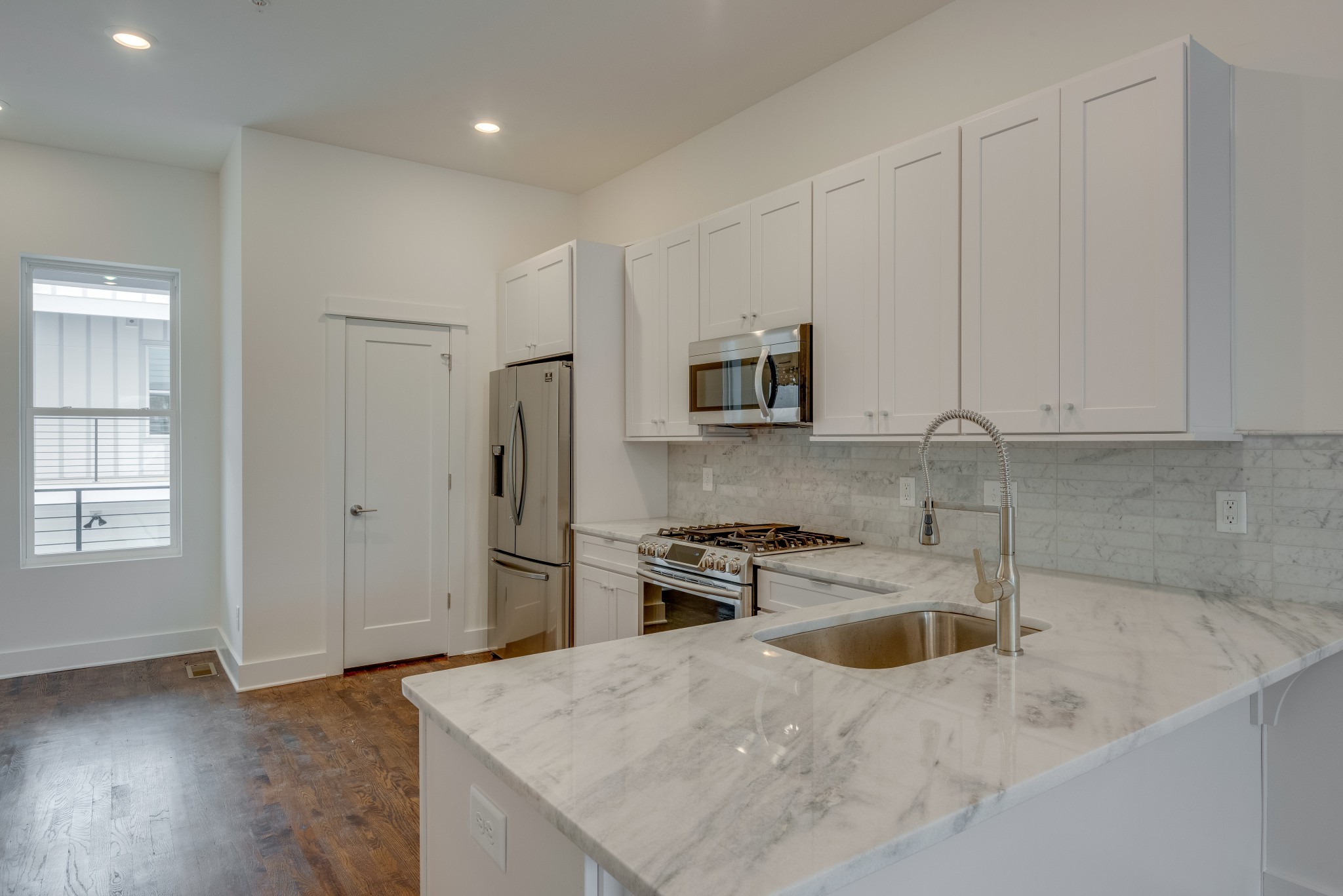2001 Convent Place, Unit 16 Nashville, TN 37212 - Photo 7 of 24 a kitchen with stainless steel appliances granite countertop a sink a stove a refrigerator a microwave and cabinets
